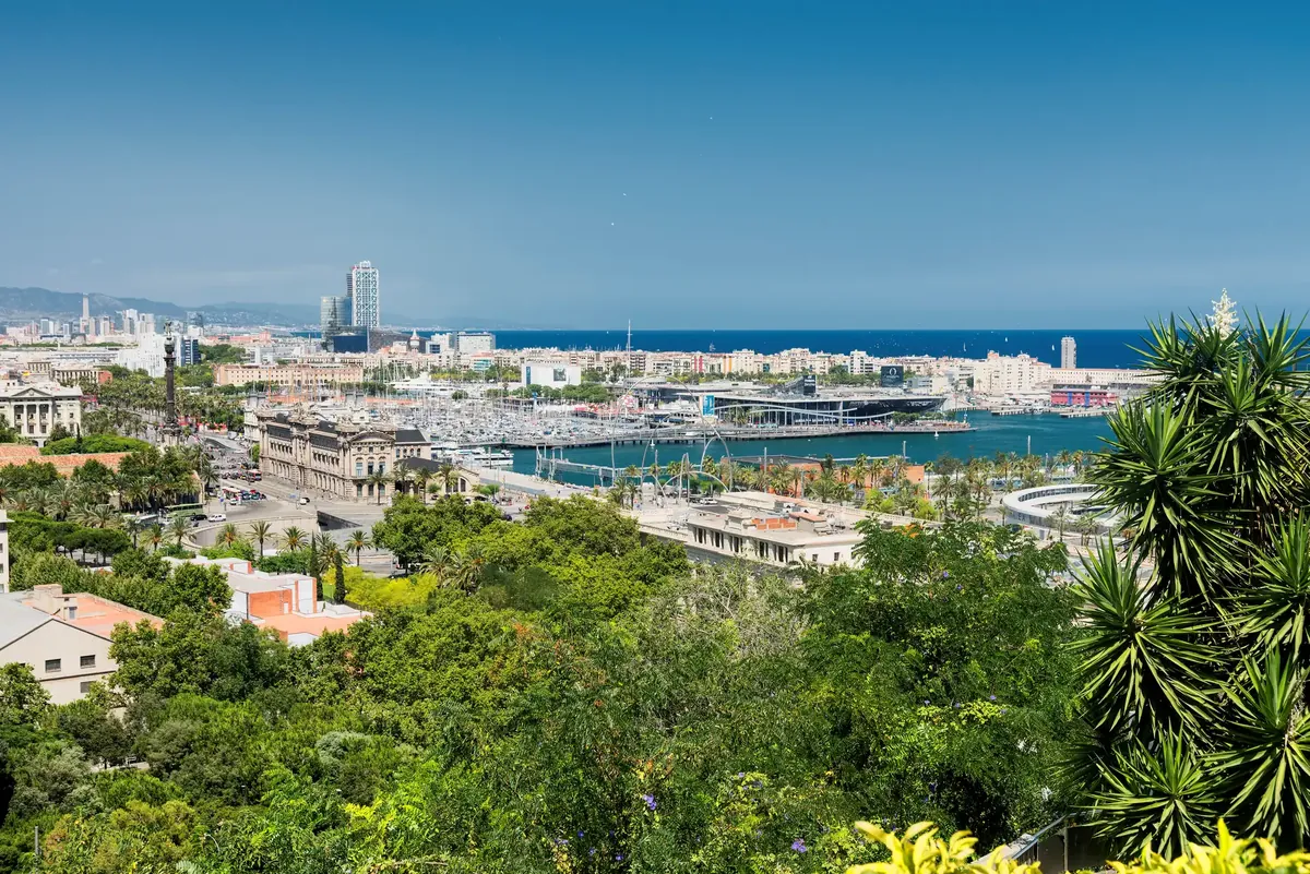 The view from Montjuïc over gardens and palms to the Port Vell marina, the seafront and the sea in Barcelona