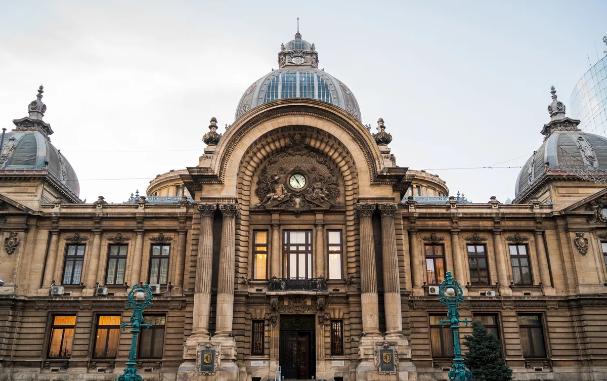 The Beaux-Arts façade of the CEC Palace in Bucharest with its glass central dome, clock and two corner domes