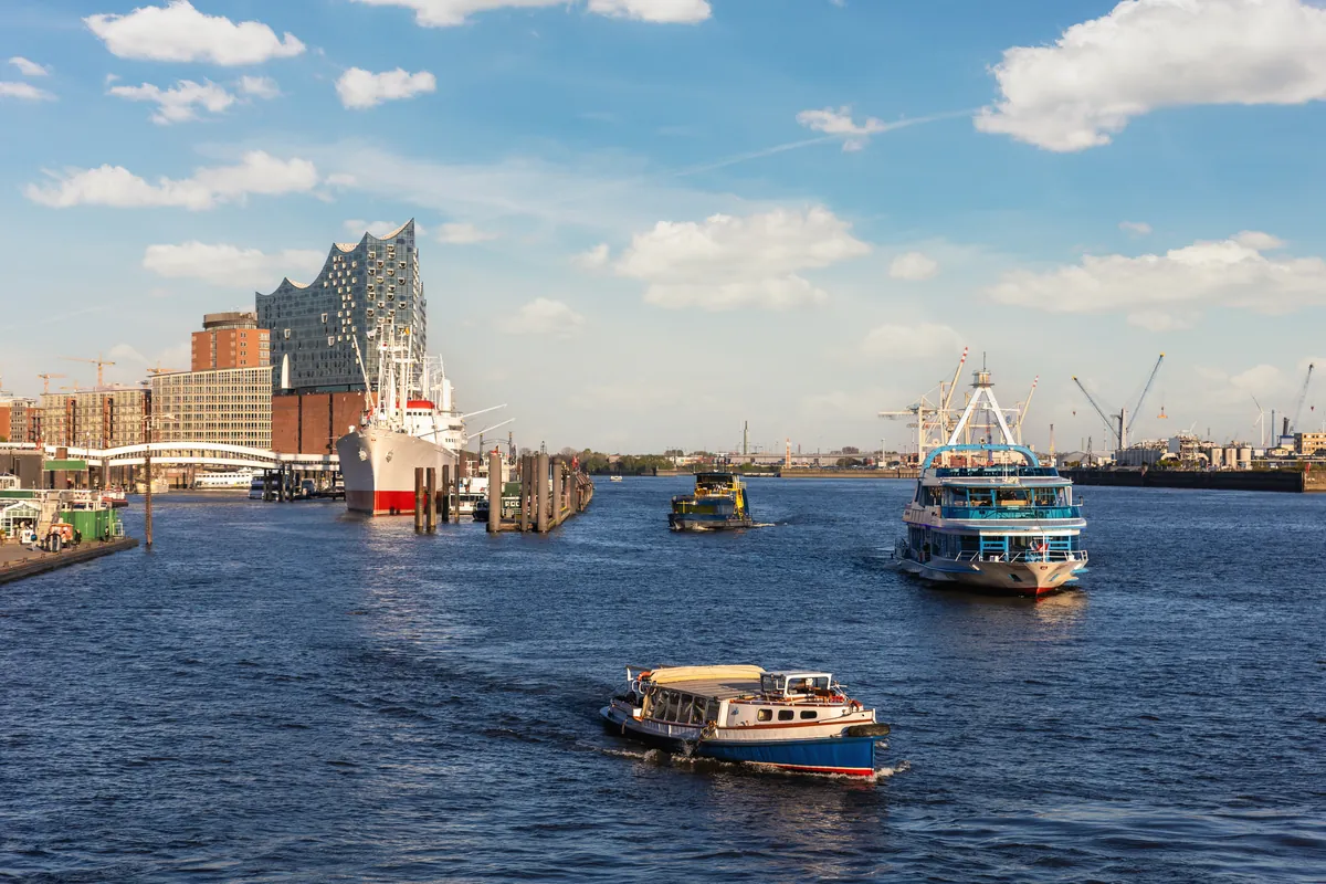 Harbour ferries on the Elbe in Hamburg with the Elbphilharmonie and the port behind