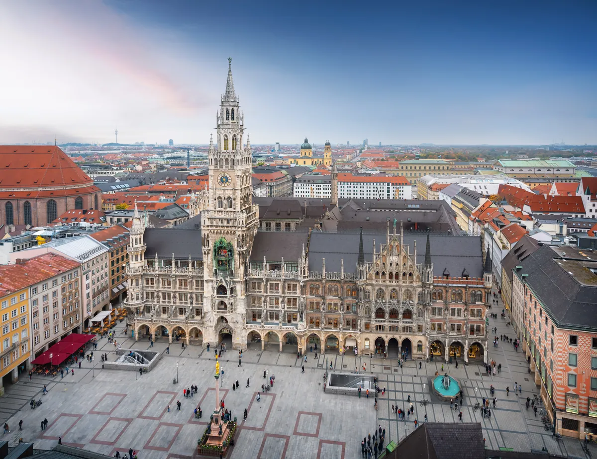 Marienplatz in Munich from above with the Gothic New Town Hall and its clock tower, the Marian Column and people crossing the square