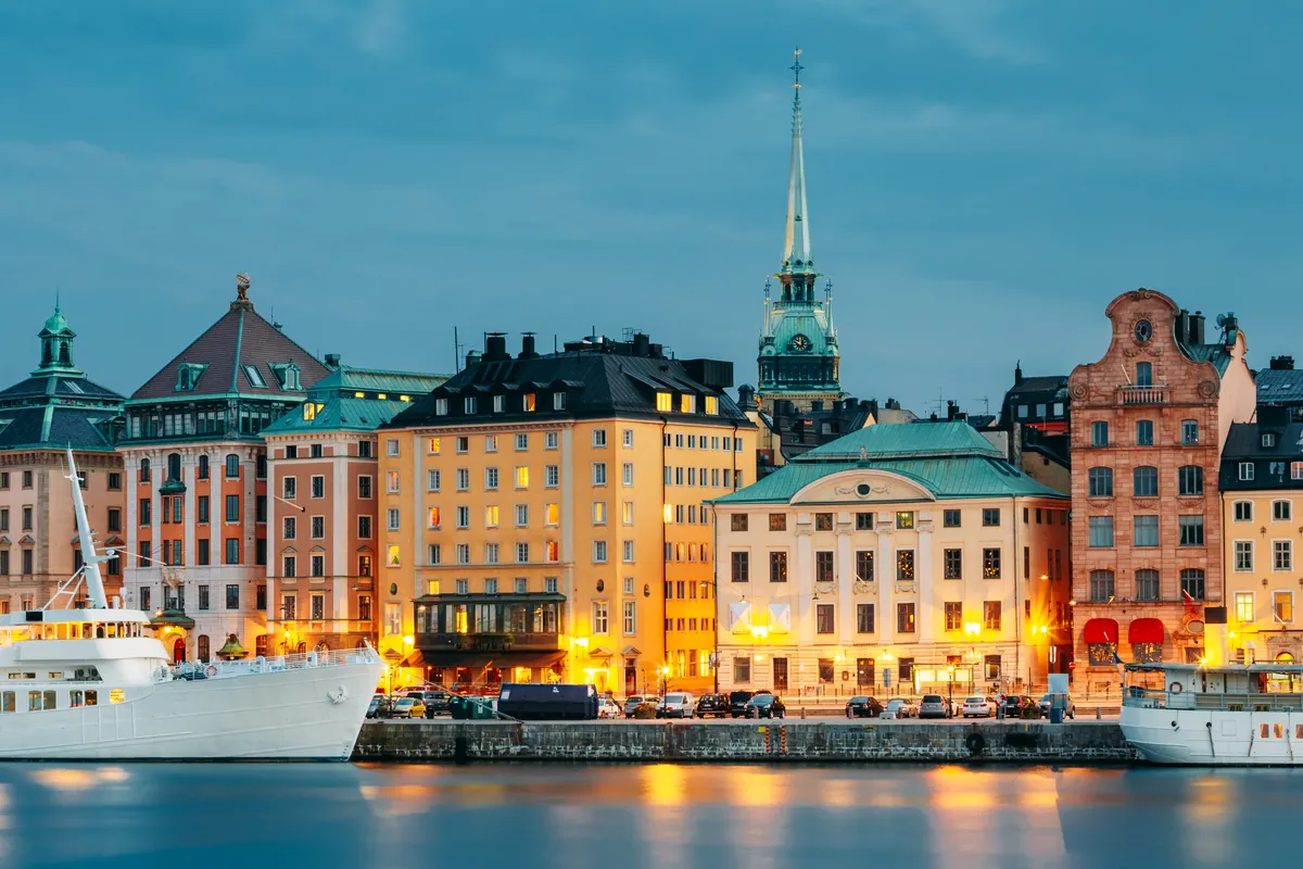 Colourful façades and boats along a Stockholm embankment on a bright summer day